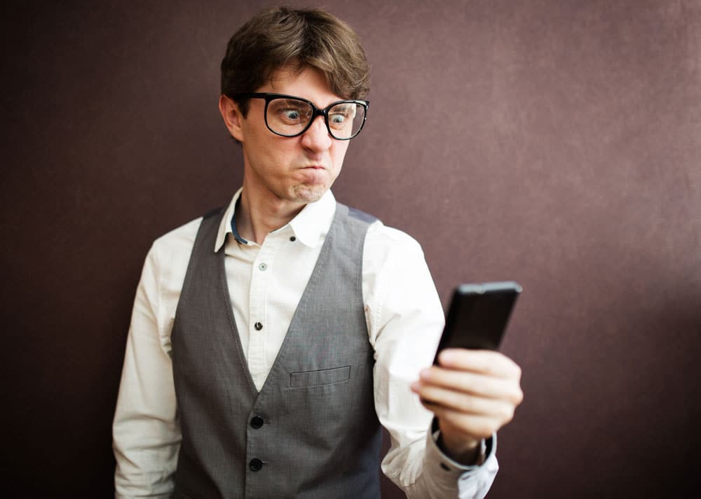 Man looking upset at phone