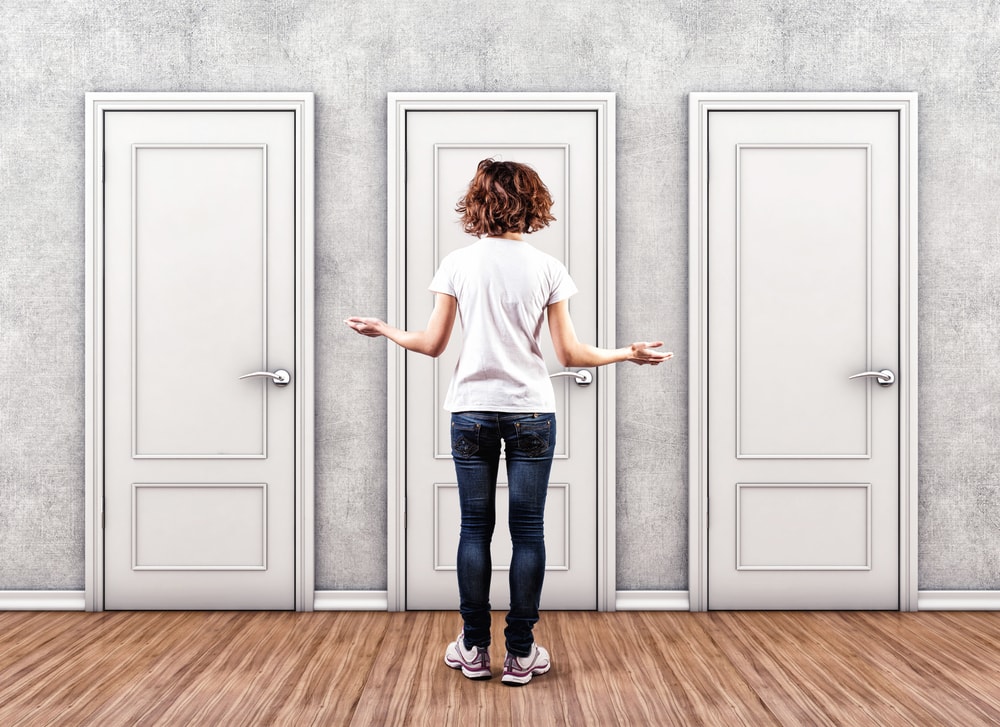 woman deciding between three doors