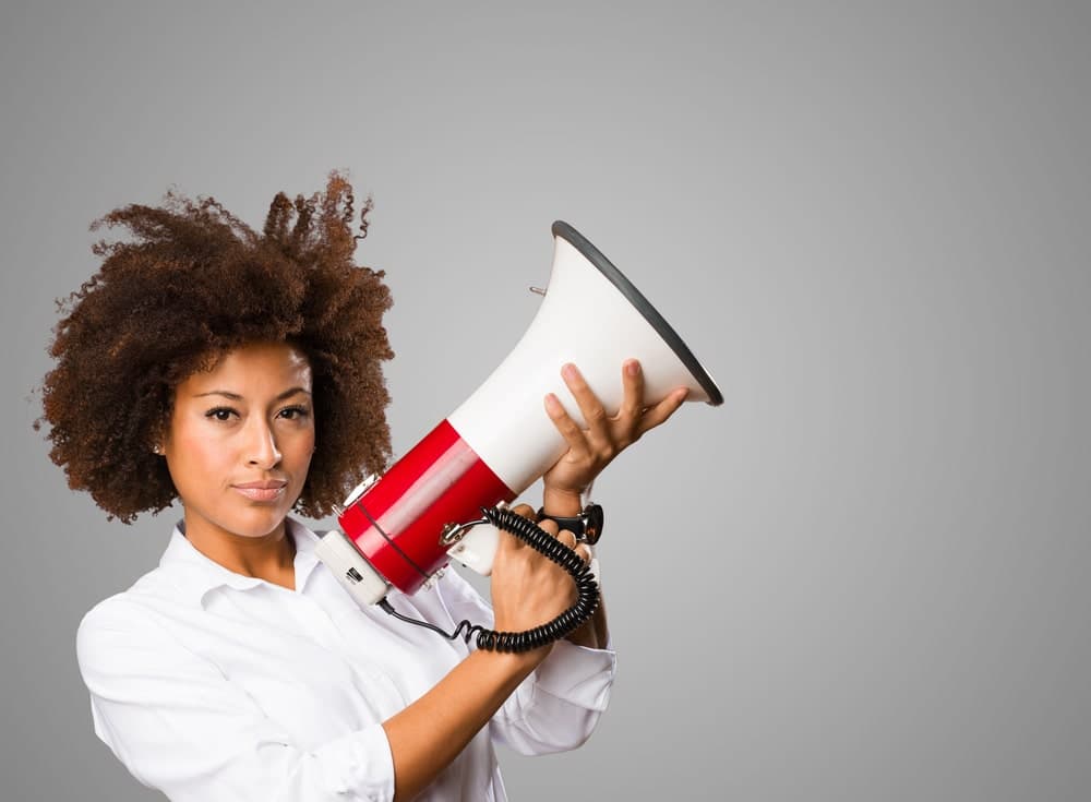 woman holding red and white megaphone
