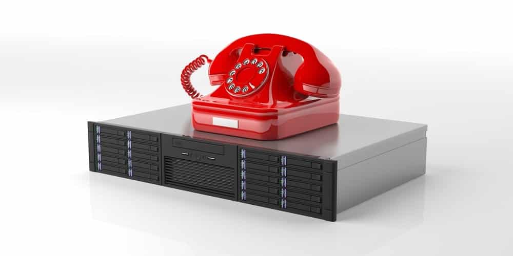red rotary phone on a server stack