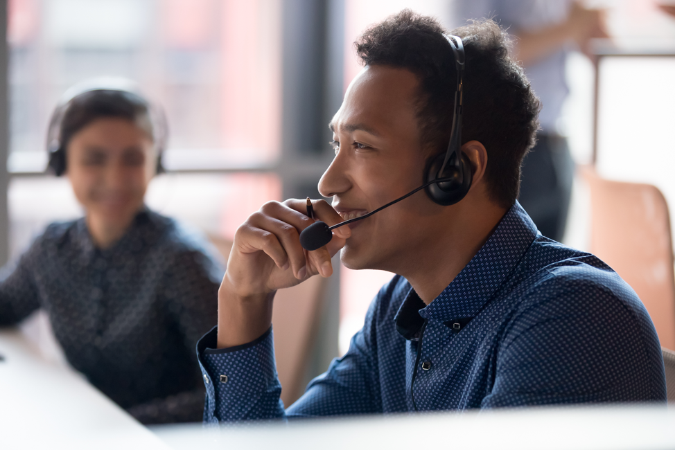 Man smiling while wearing phone headset