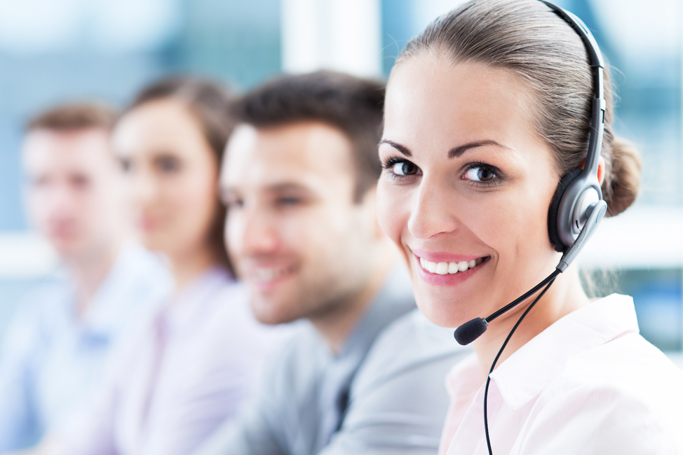 woman smiling while wearing phone headset